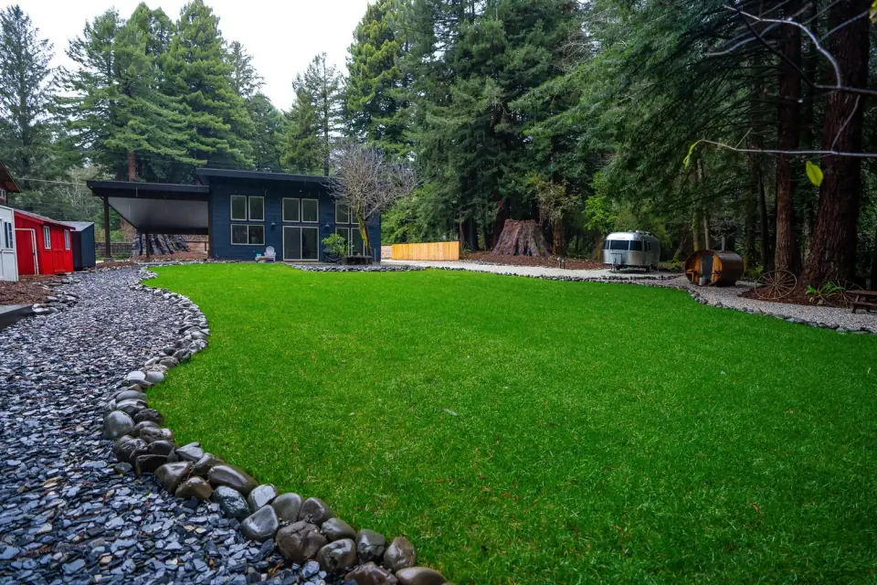 Finished turf lawn with a natural river-rock border in a J&G Lawn & Garden design-build, Humboldt County